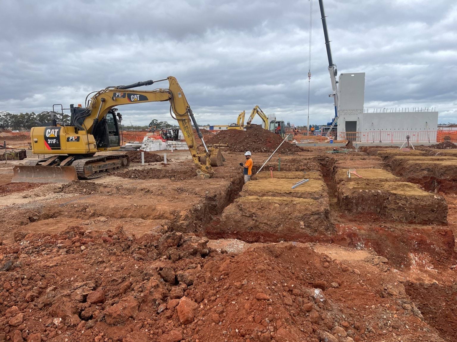 Aintree Secondary School (interim name) - construction photo of site progress in March 2023 - a mechanical digger creating foundations