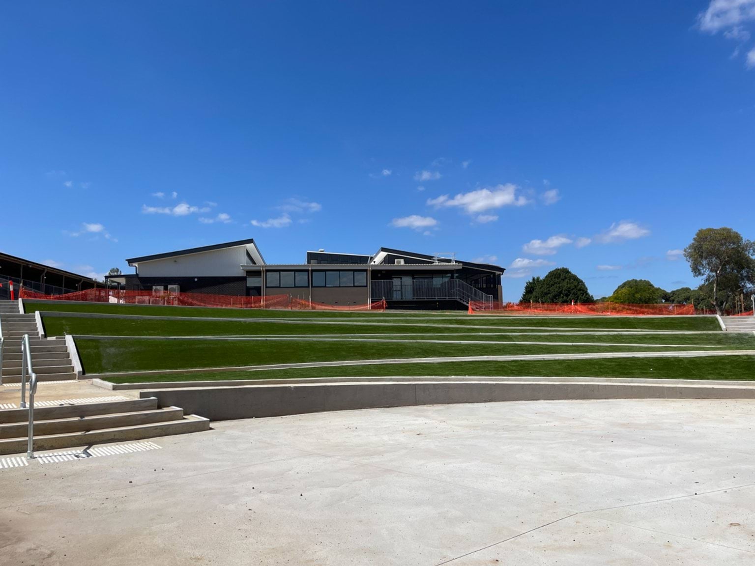 Warragul Regional College - photo showing steps landscaped into a green space in front of a new school building
