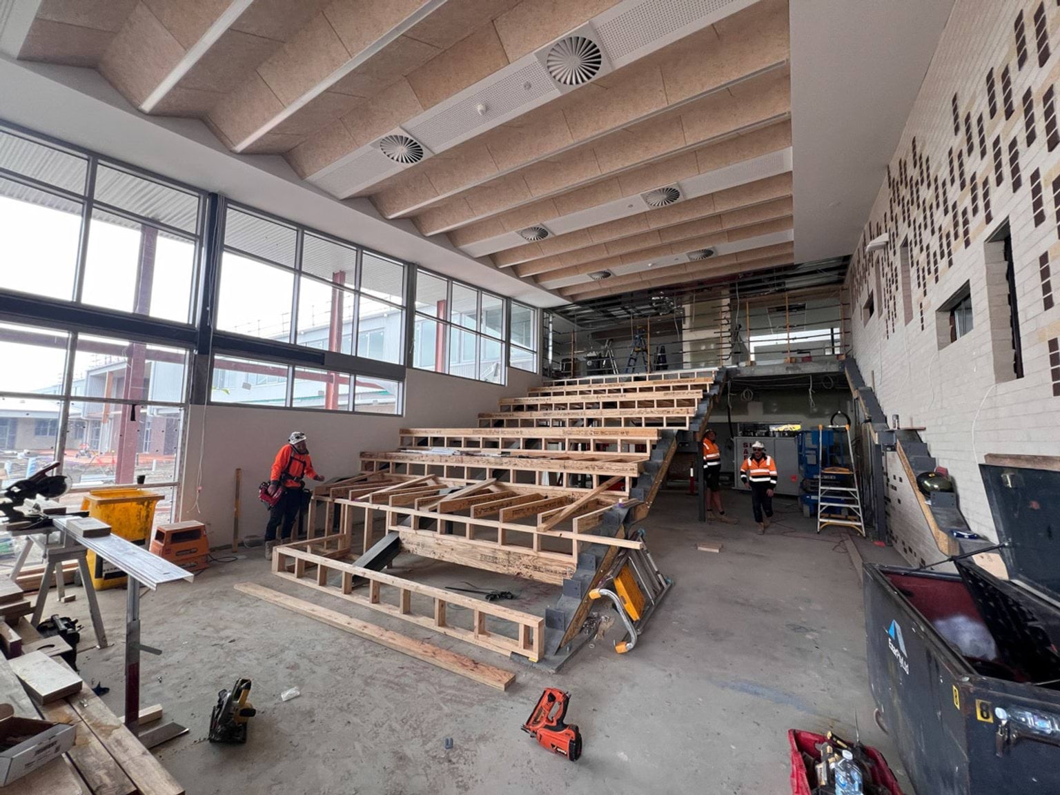 Timber seating for indoor amphitheatre being constructed 