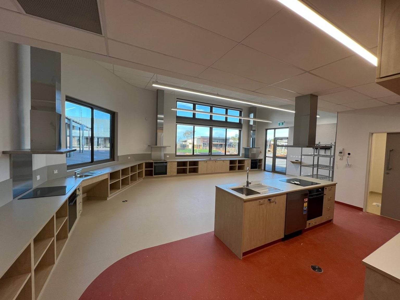Kitchenette island within new classroom area. Striking red floor markings that demarcates separate zones.