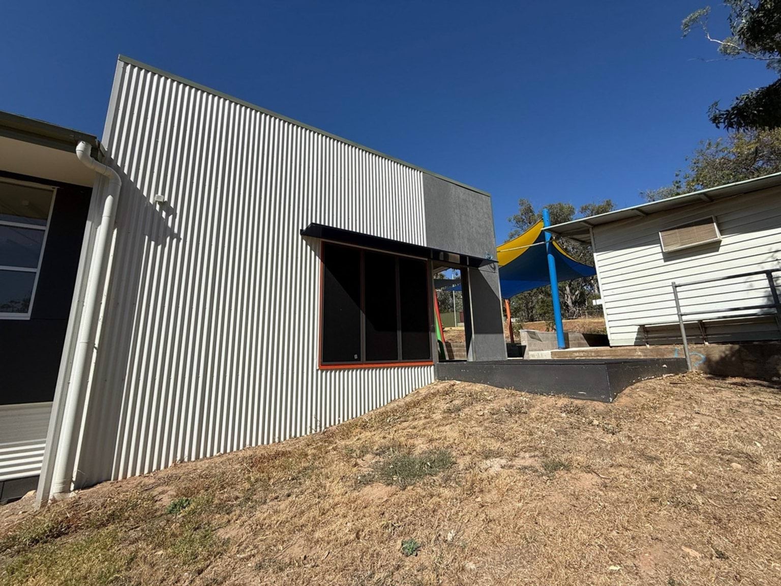 Outdoor photo of a school building with a metal exterior.