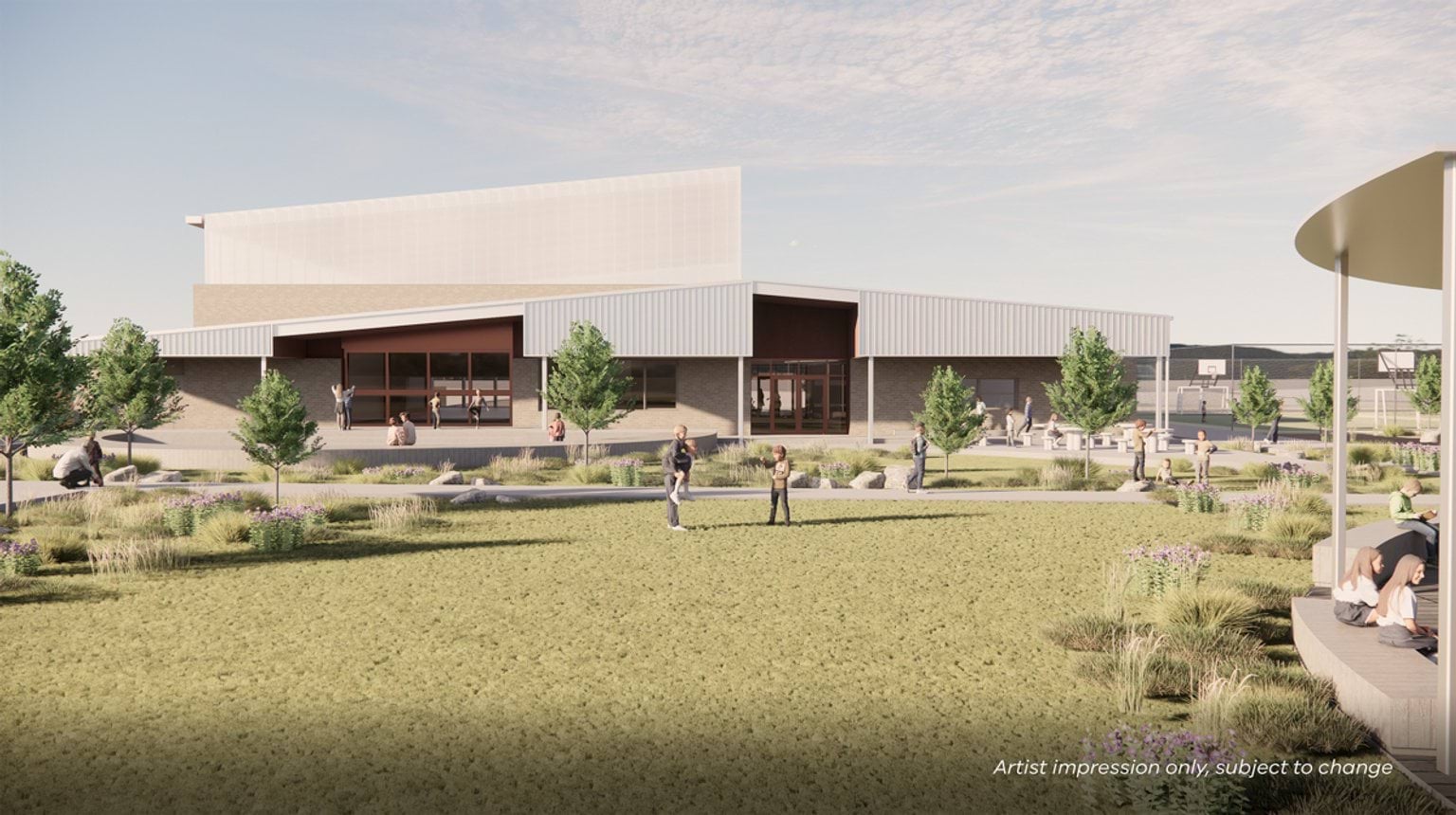 Render of outdoor area at school. There is a lawn with two children on it, a shaded seating area, and a school building in the background.