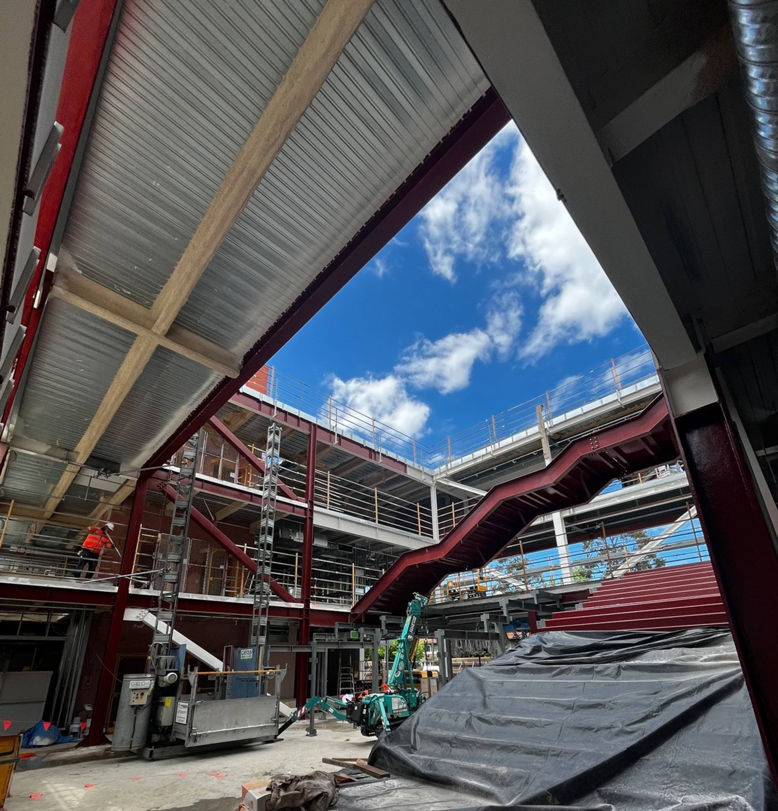 Internal courtyard features a red zig zag staircase crossing from one side of the building to the other. 