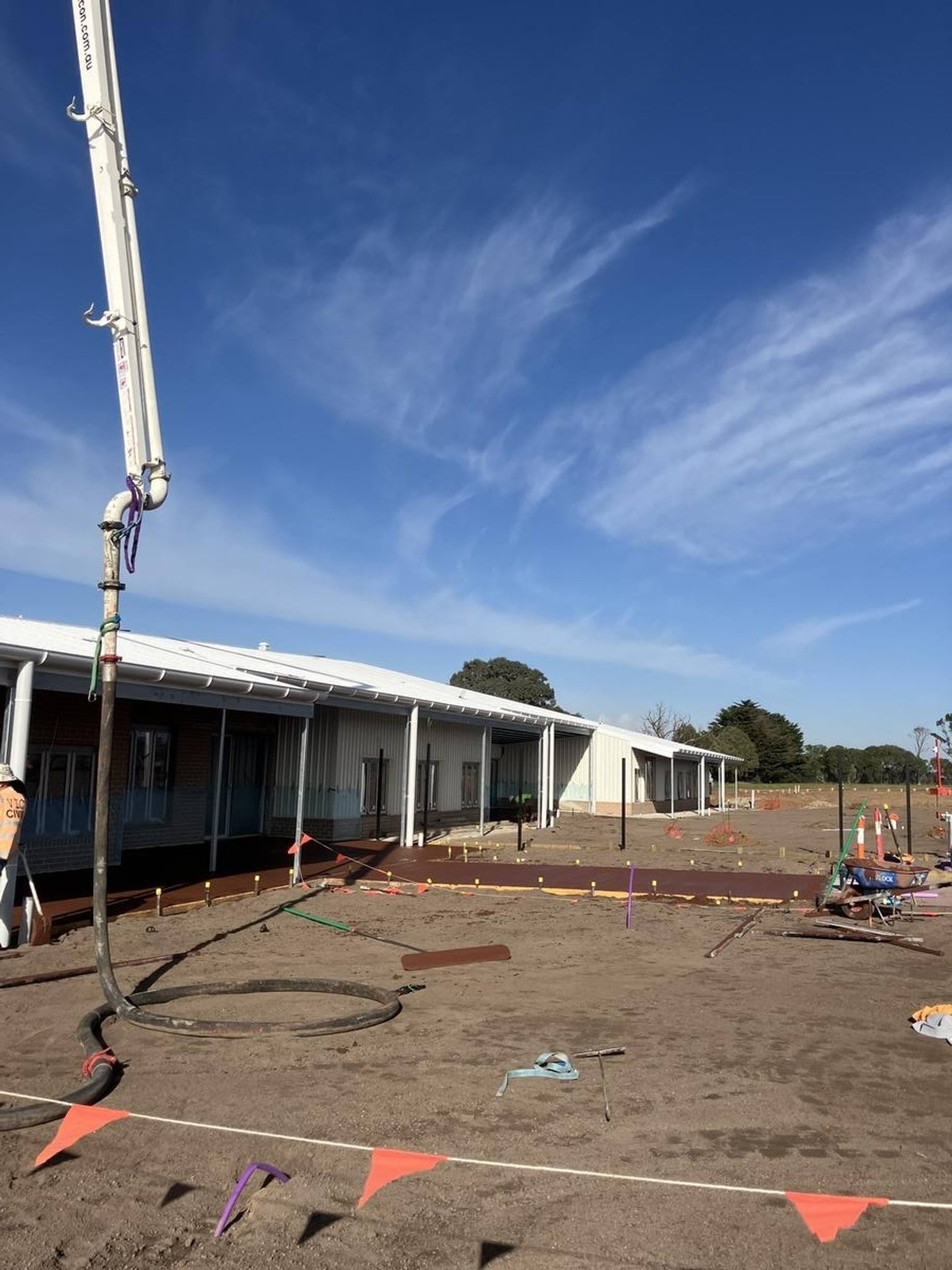 New red path leading under eaves if new school building 