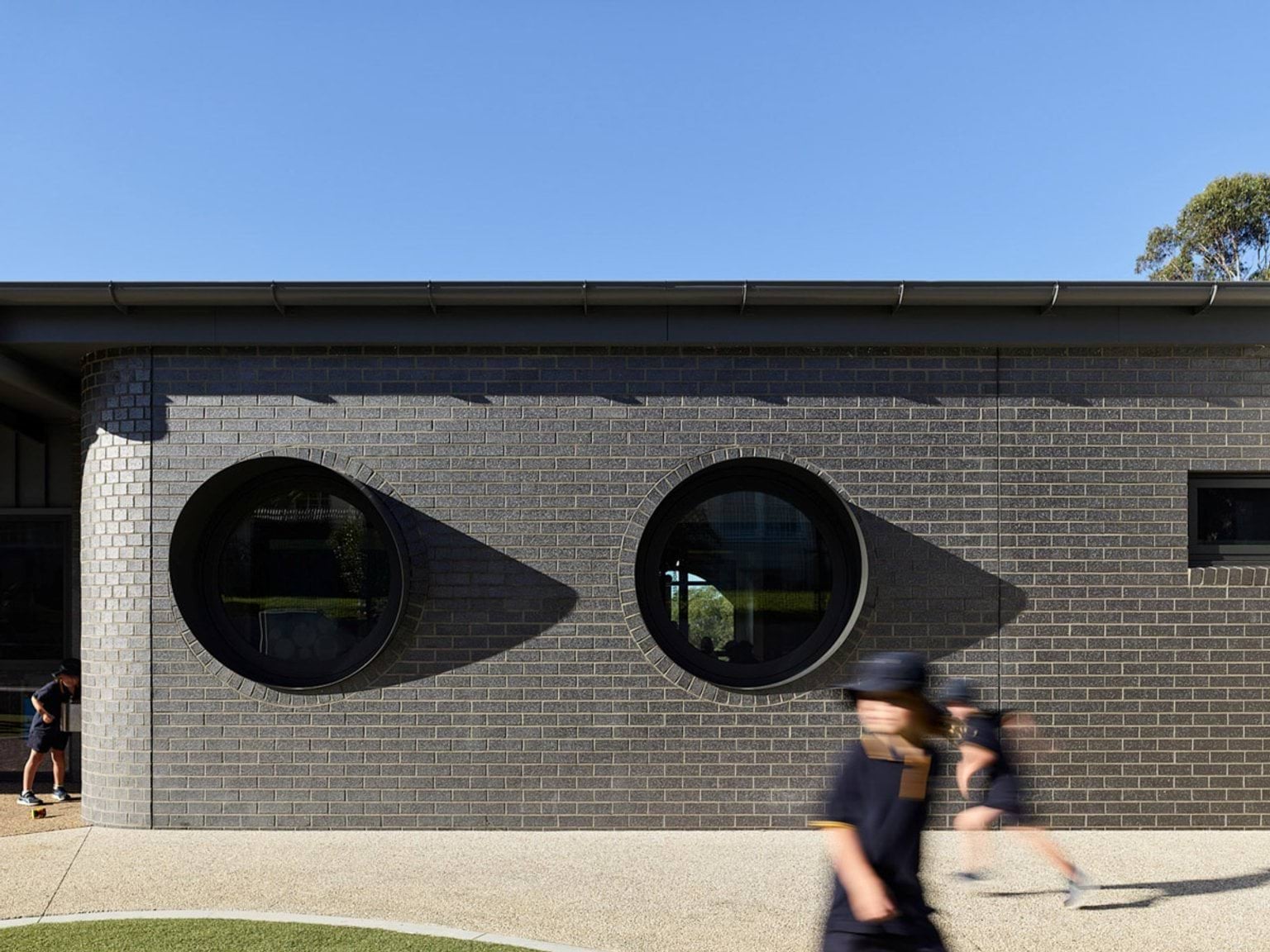 Exterior brick wall with two large circular windows