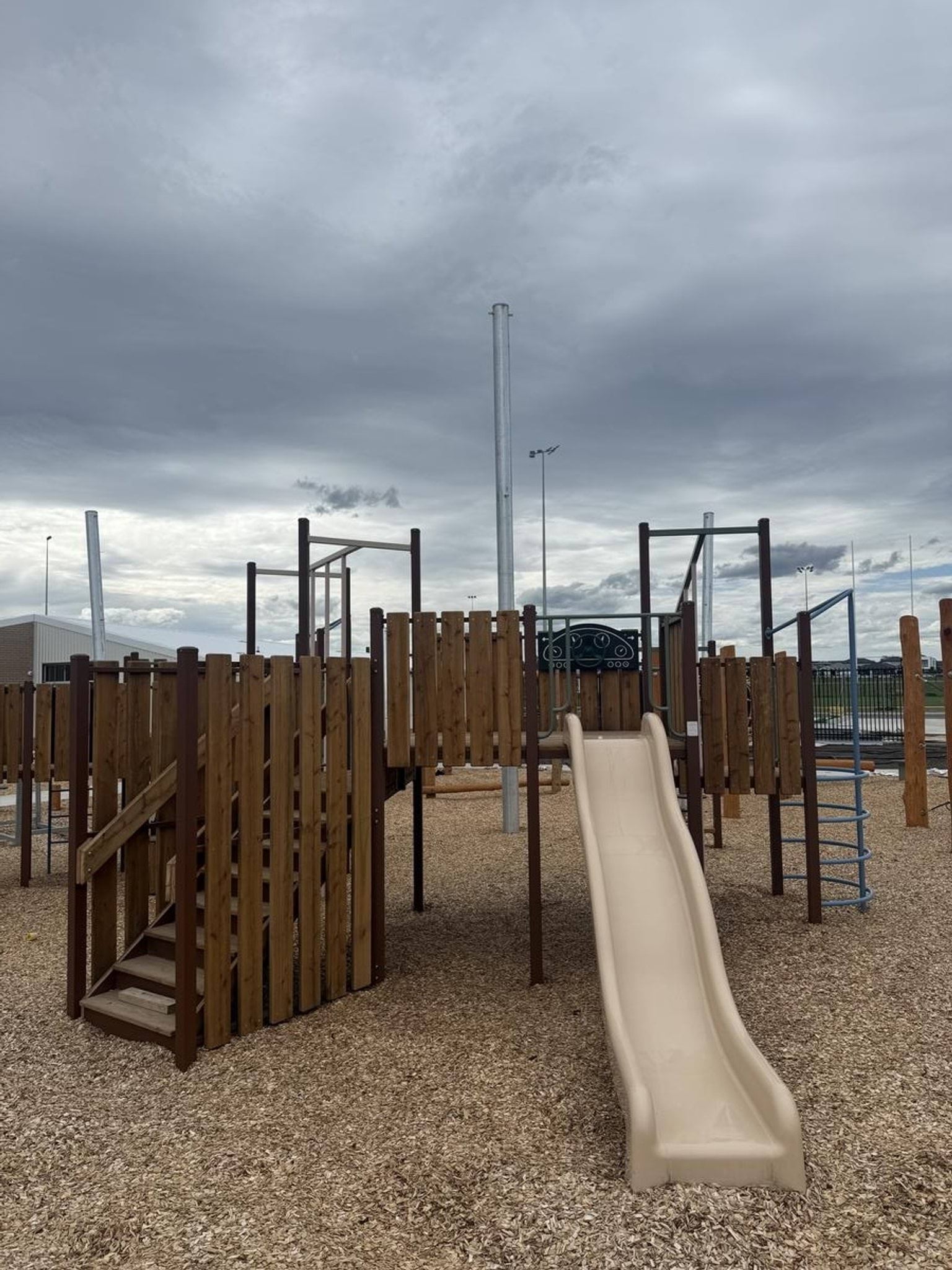 The new playground (a slide and wooden fort structure) at Early Learning Victoria Gamadji