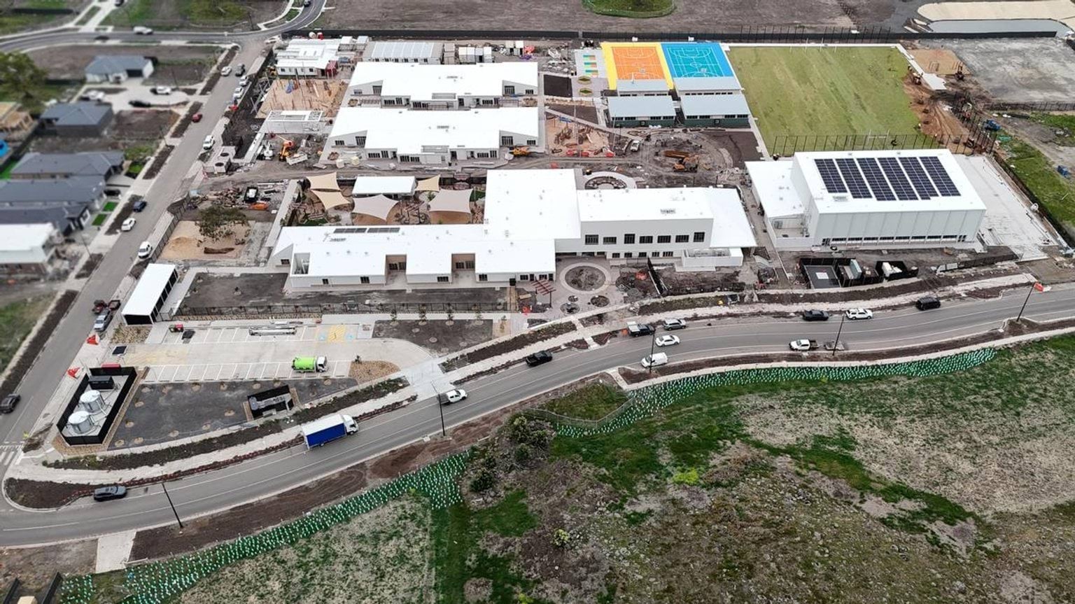 Overhead shot of school complex showing solar panels and road access