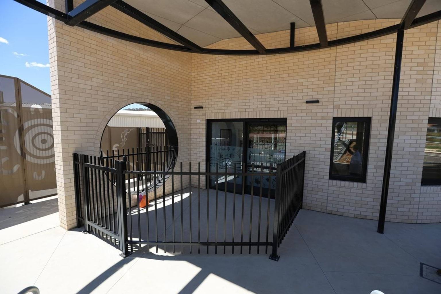 An outside area of Kerribana Primary School Kindergarten (interim name) with an enclosed space within a fence. 