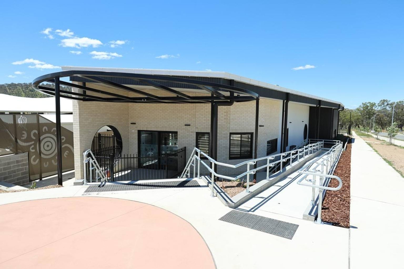 Outside Kerribana Primary School Kindergarten (interim name), looking at a building with a ramp leading down to it. 