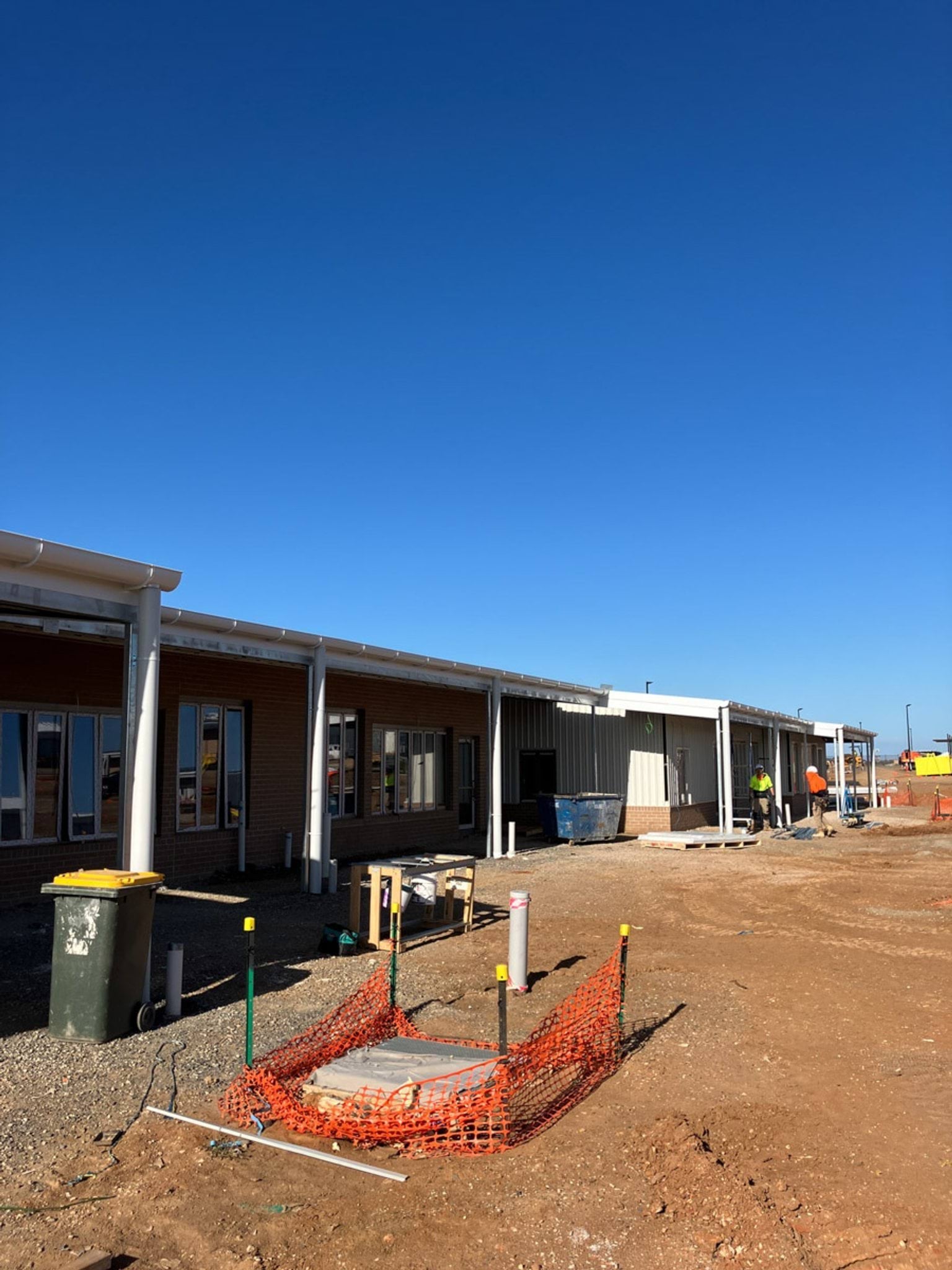 Outdoor photo of school buildings under construction