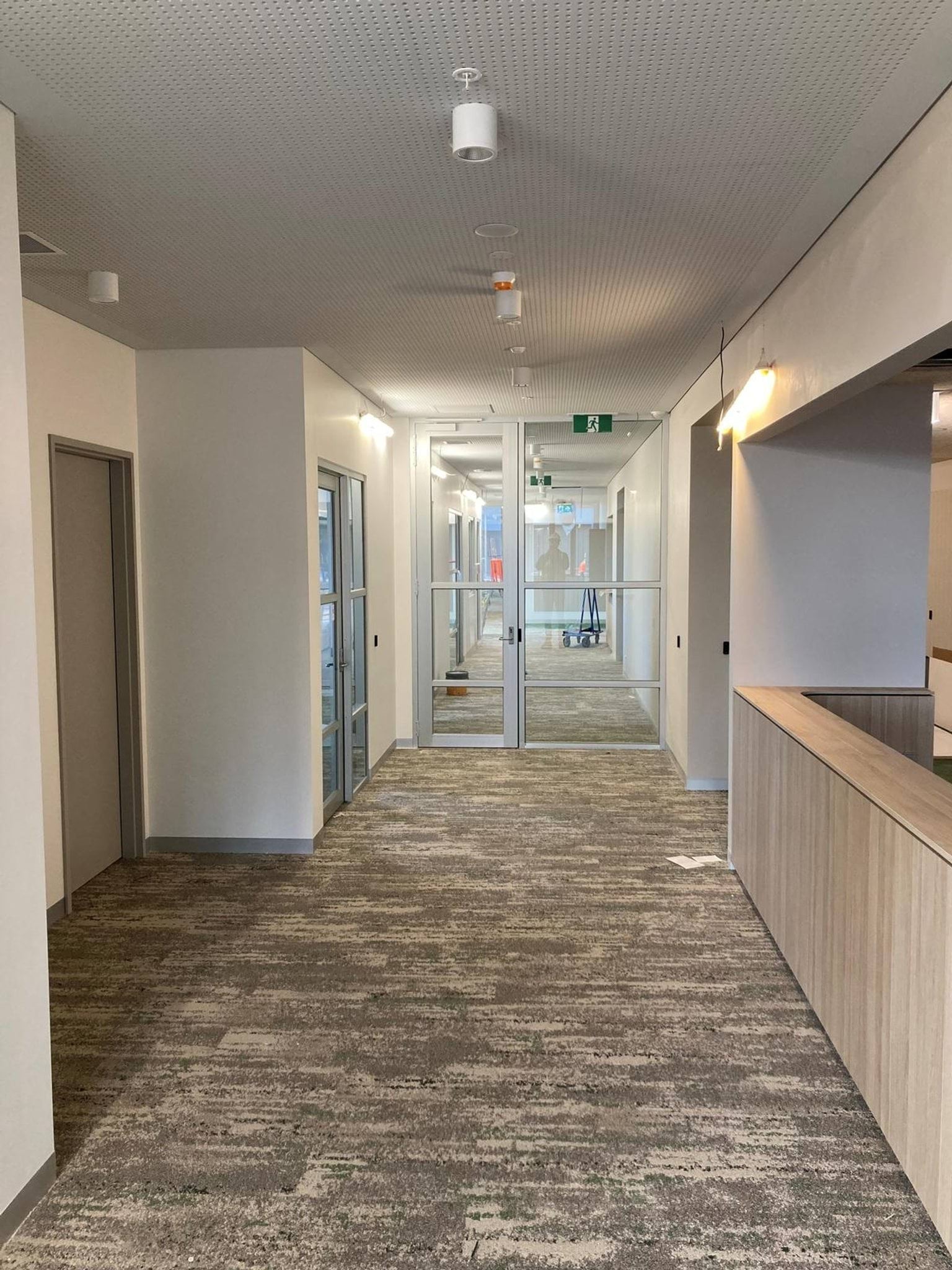Hallway in school building with reception desk and doorway