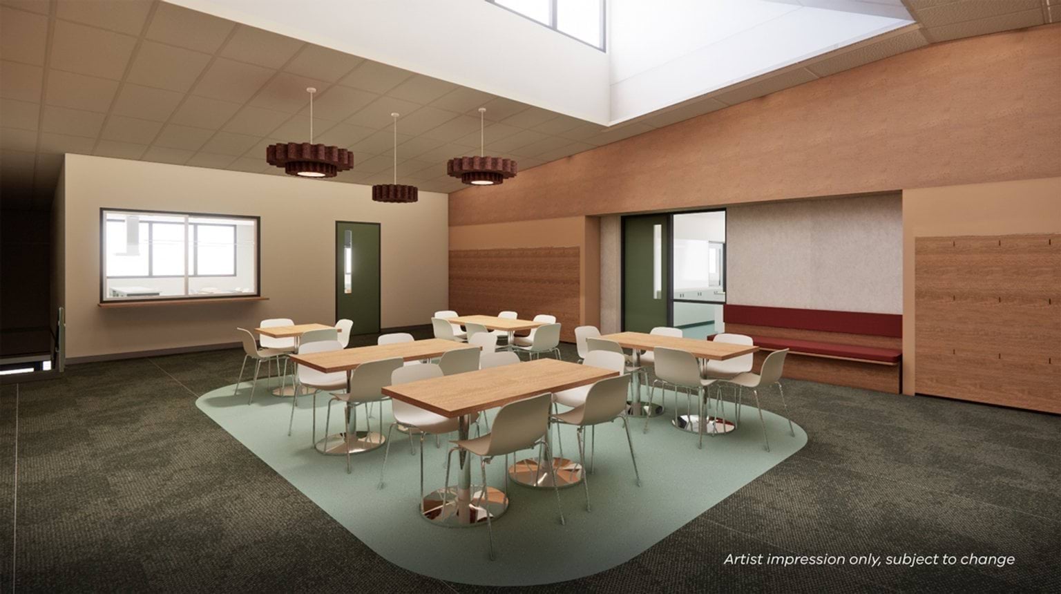 Artist impression of a classroom with grouped tables and chairs, skylight above, timber wall panels, built‑in seating, and soft carpeted flooring.