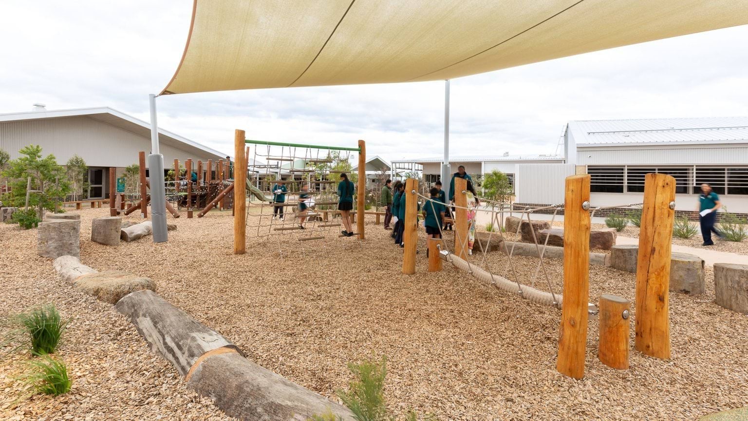 Students playing in covered outdoor playground area