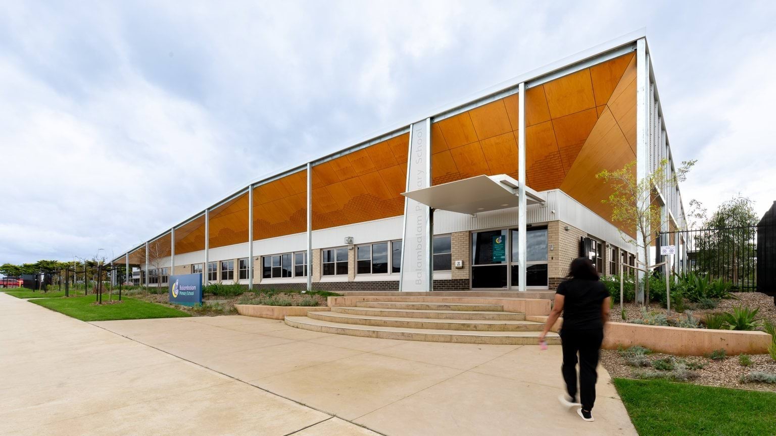 Person walking toward main school building entrance