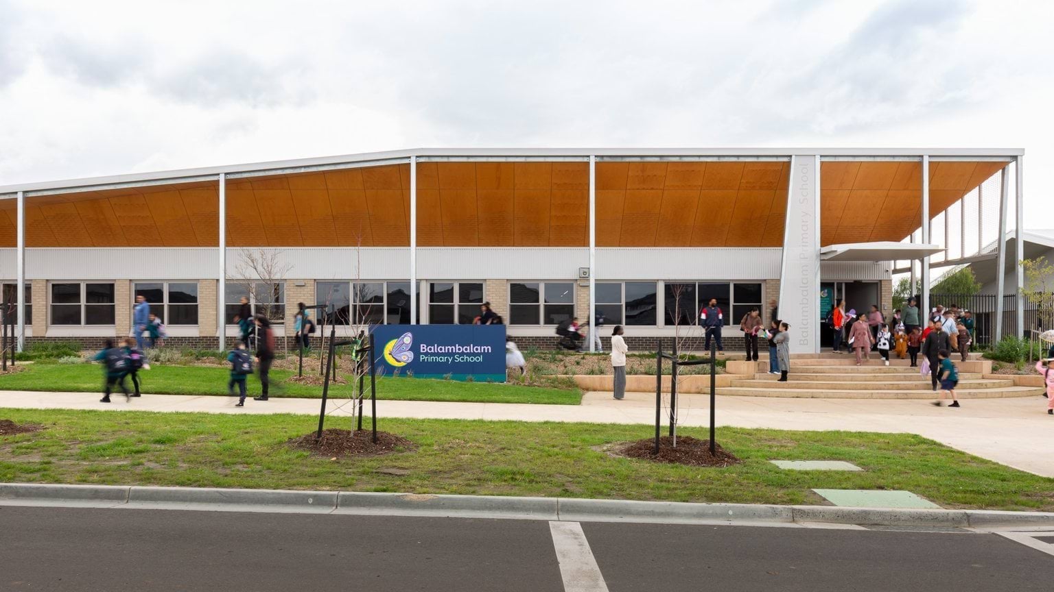 Students and parents exiting school building entrance
