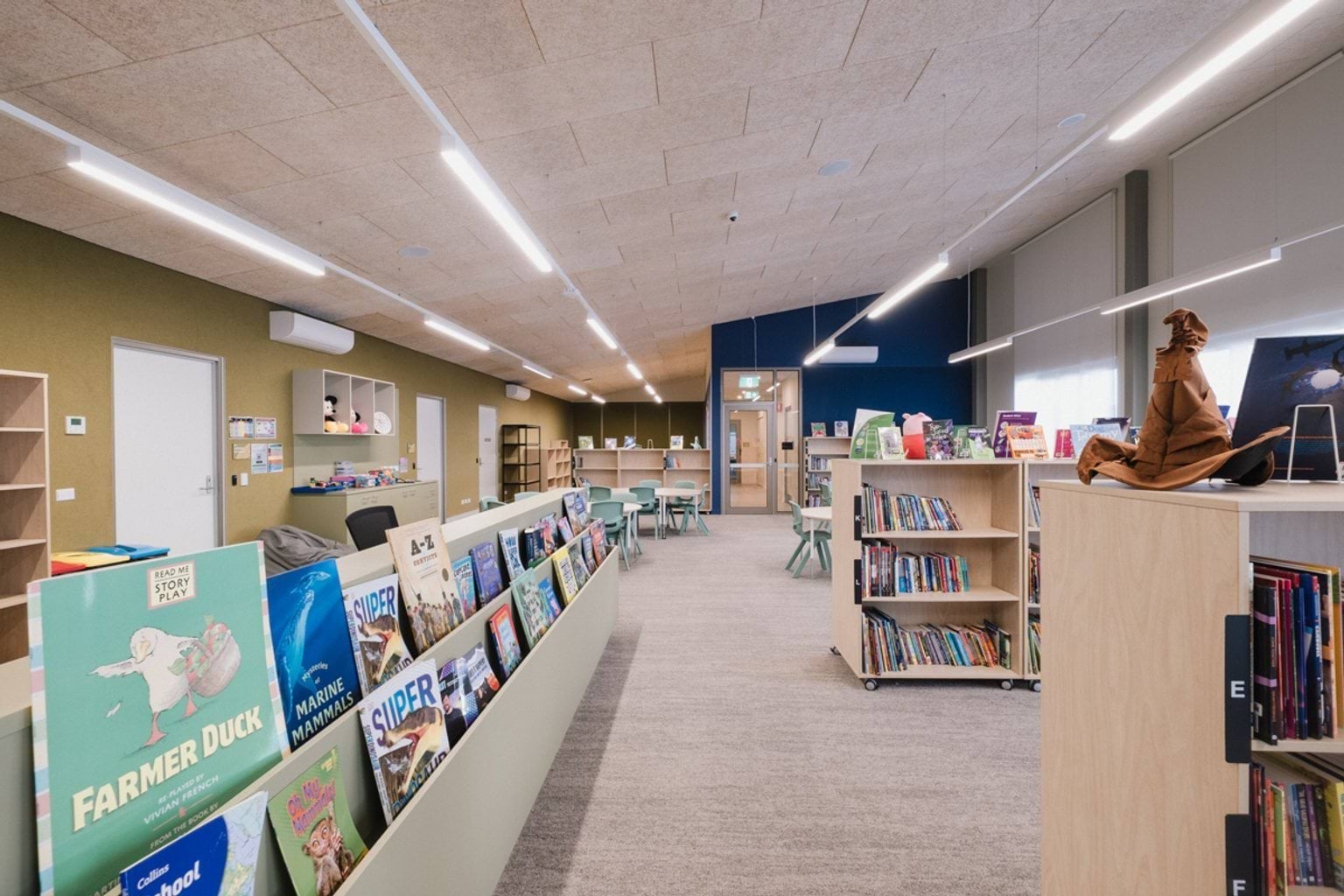 Library with grey carpet, bookshelves filled with books