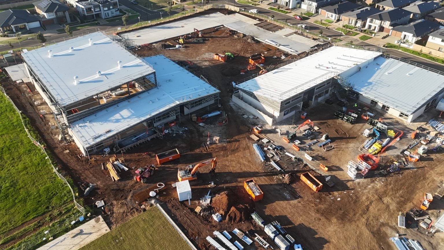 View from above of construction site with two large buildings