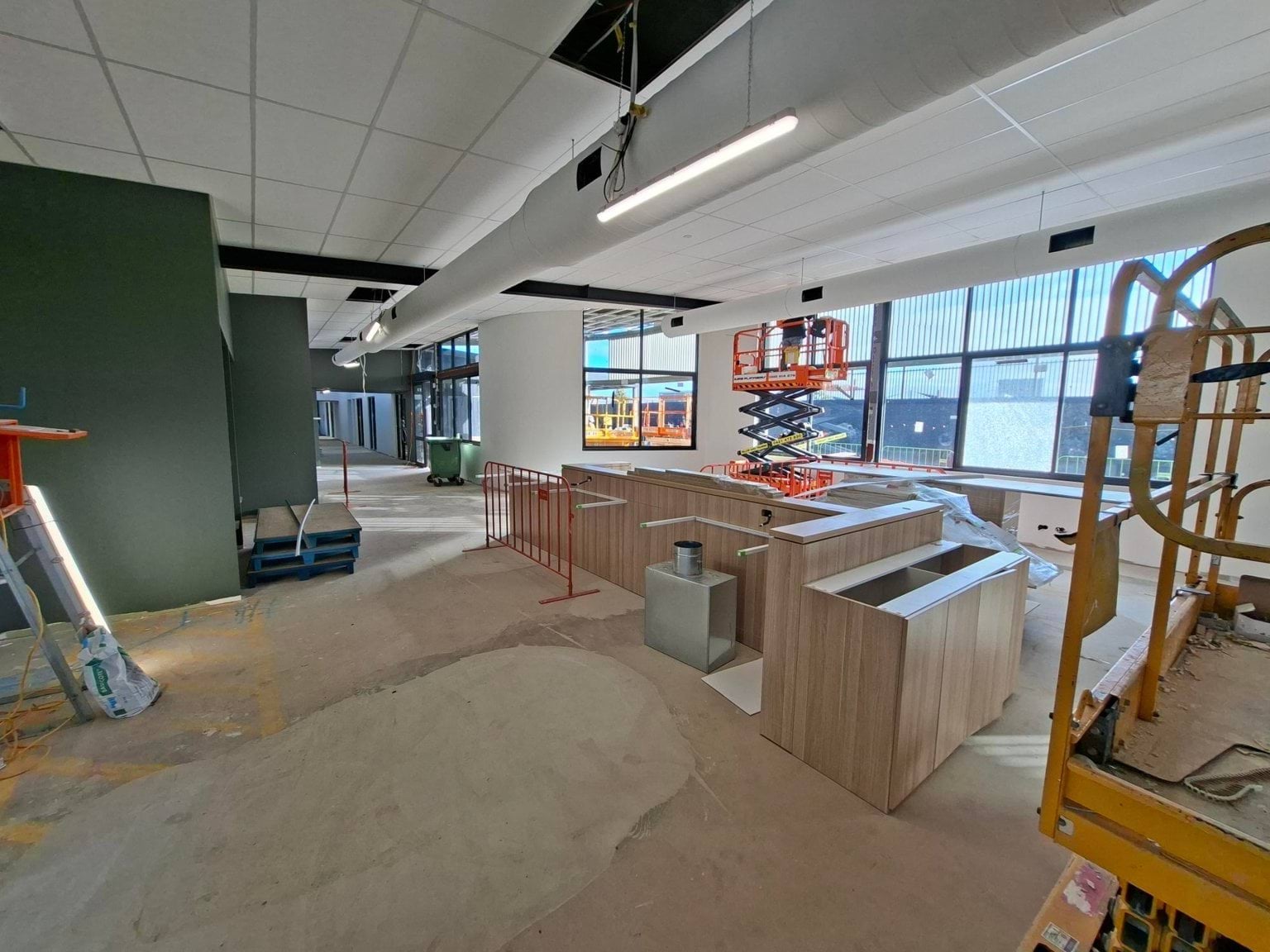 A break-out area under construction with green and wooden fittings